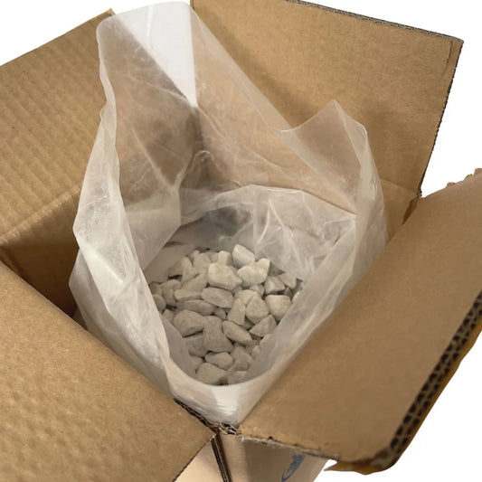Bag of aquarium filter media rocks in open cardboard box for reef tank use