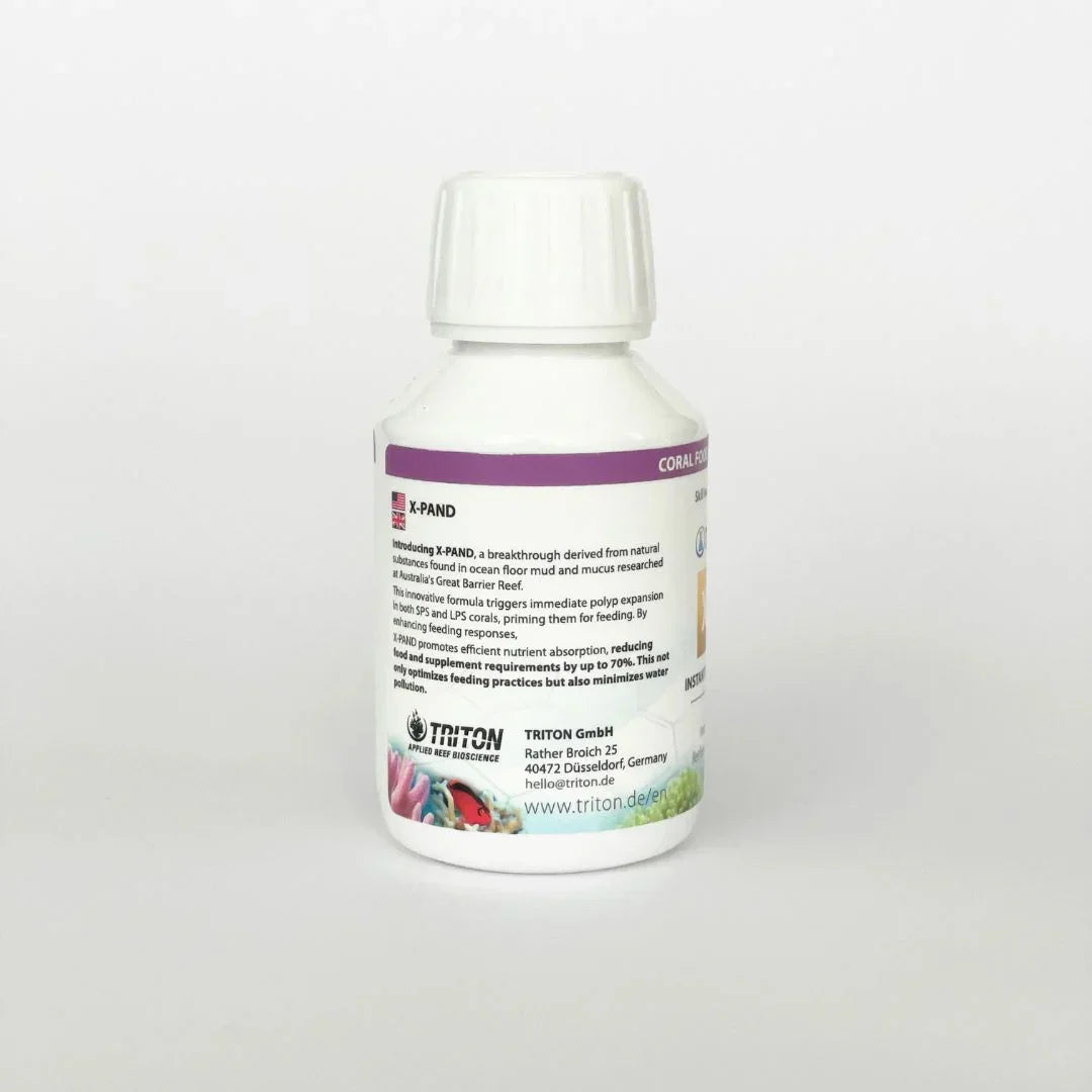 White bottle of X-PAND coral food supplement with detailed label, for saltwater aquarium corals.